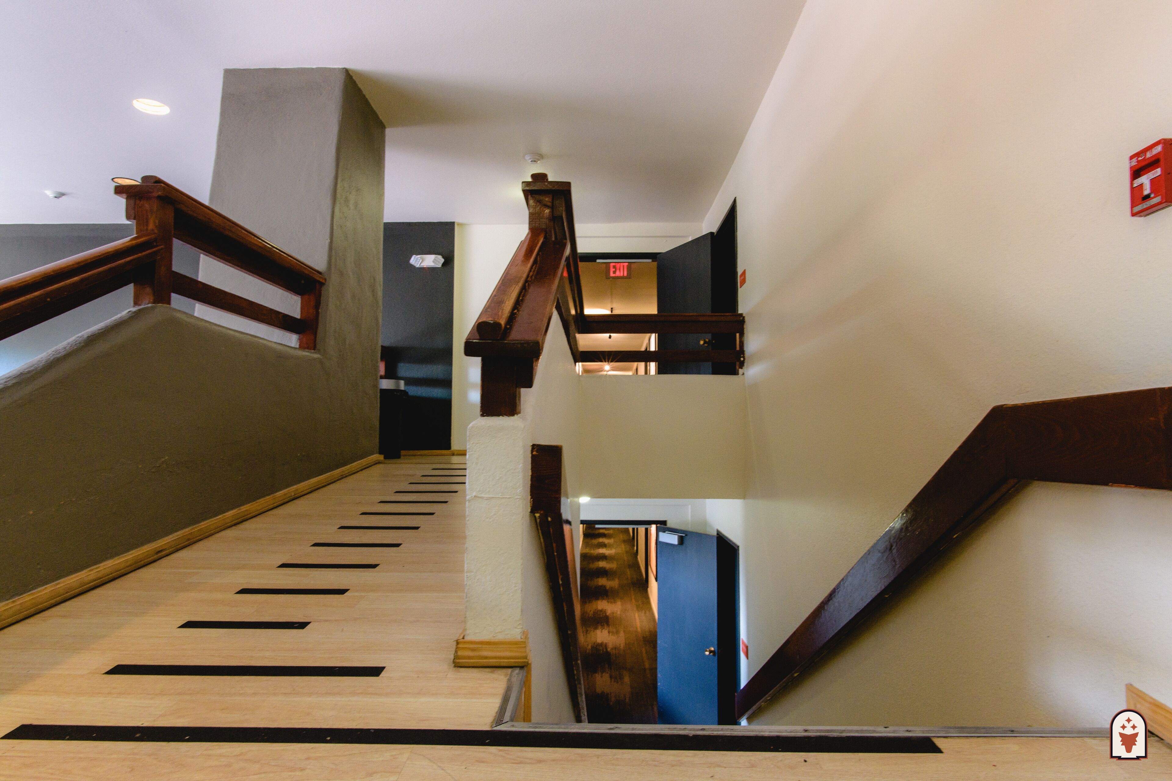 A wooden staircase with a handrail, leading to an upper floor.
