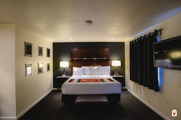 Suite, 1 King Bed (Coyote Suite) | Desk, laptop workspace, blackout curtains, iron/ironing board