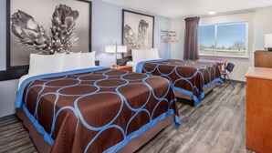 A hotel room with two beds, a desk, a chair, a lamp, and a window with a view.