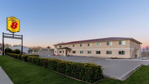 A Super 8 motel with a flat-roofed building, a parking lot, and a well-maintained lawn.