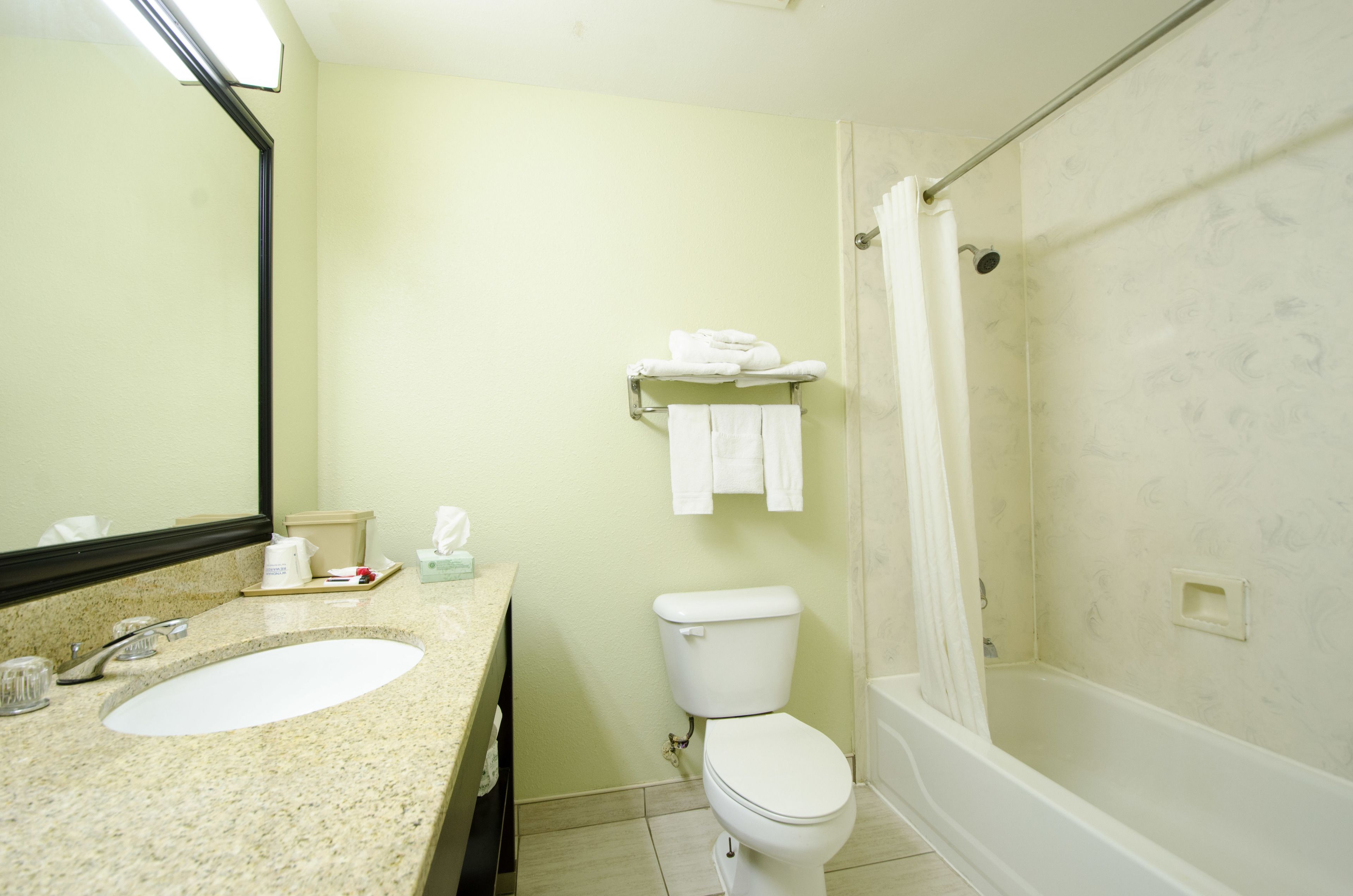 A bathroom with a sink, toilet, and shower.