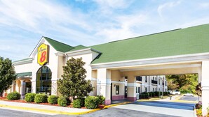 A Super 8 hotel with a green roof, covered parking, and a landscaped entrance.