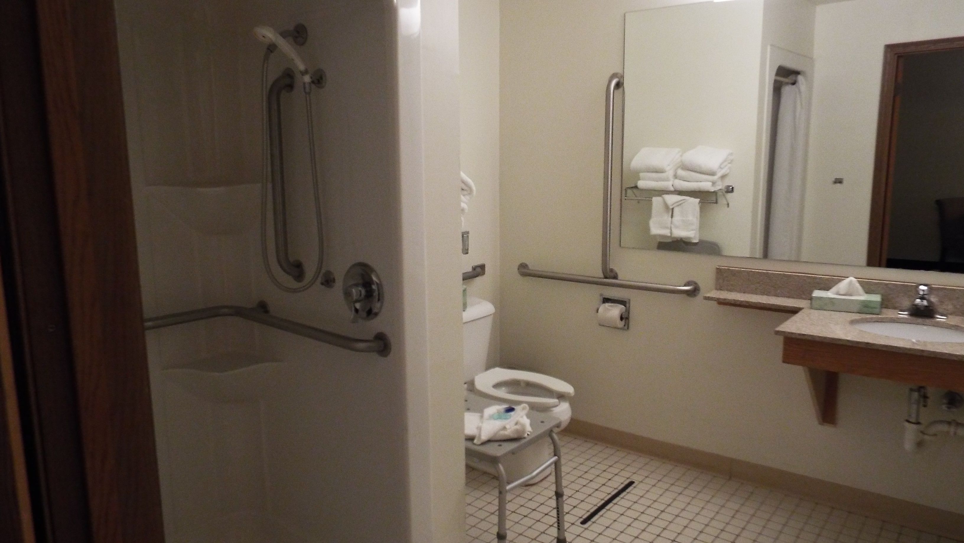 A bathroom with a shower, toilet, and sink.