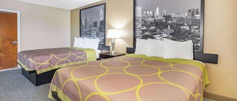 A hotel room with two beds, a cityscape view, and a lamp on the nightstand.
