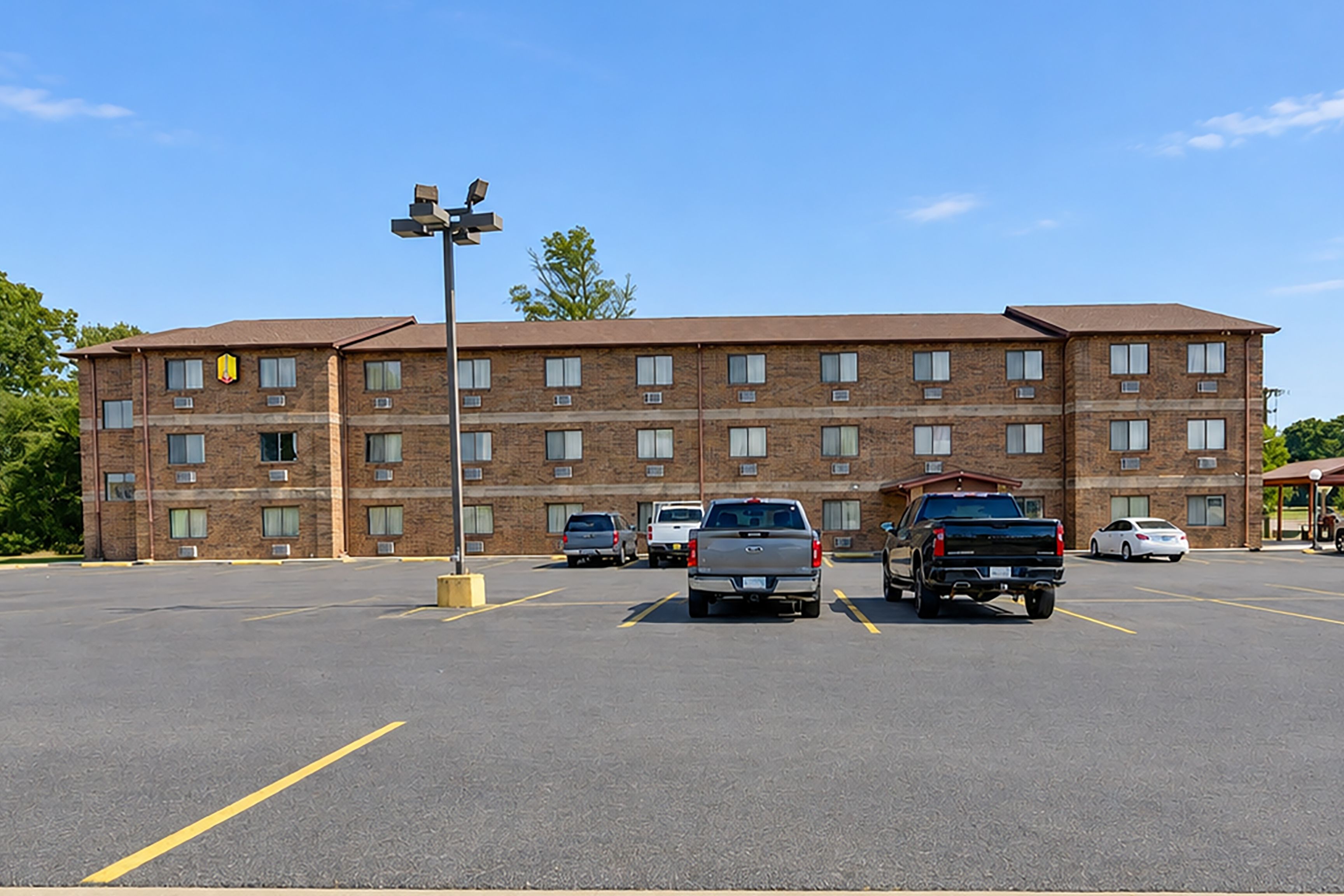 A multi-story hotel with a parking lot.