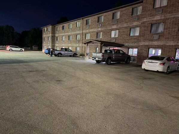 A multi-story brick building with a parking lot.