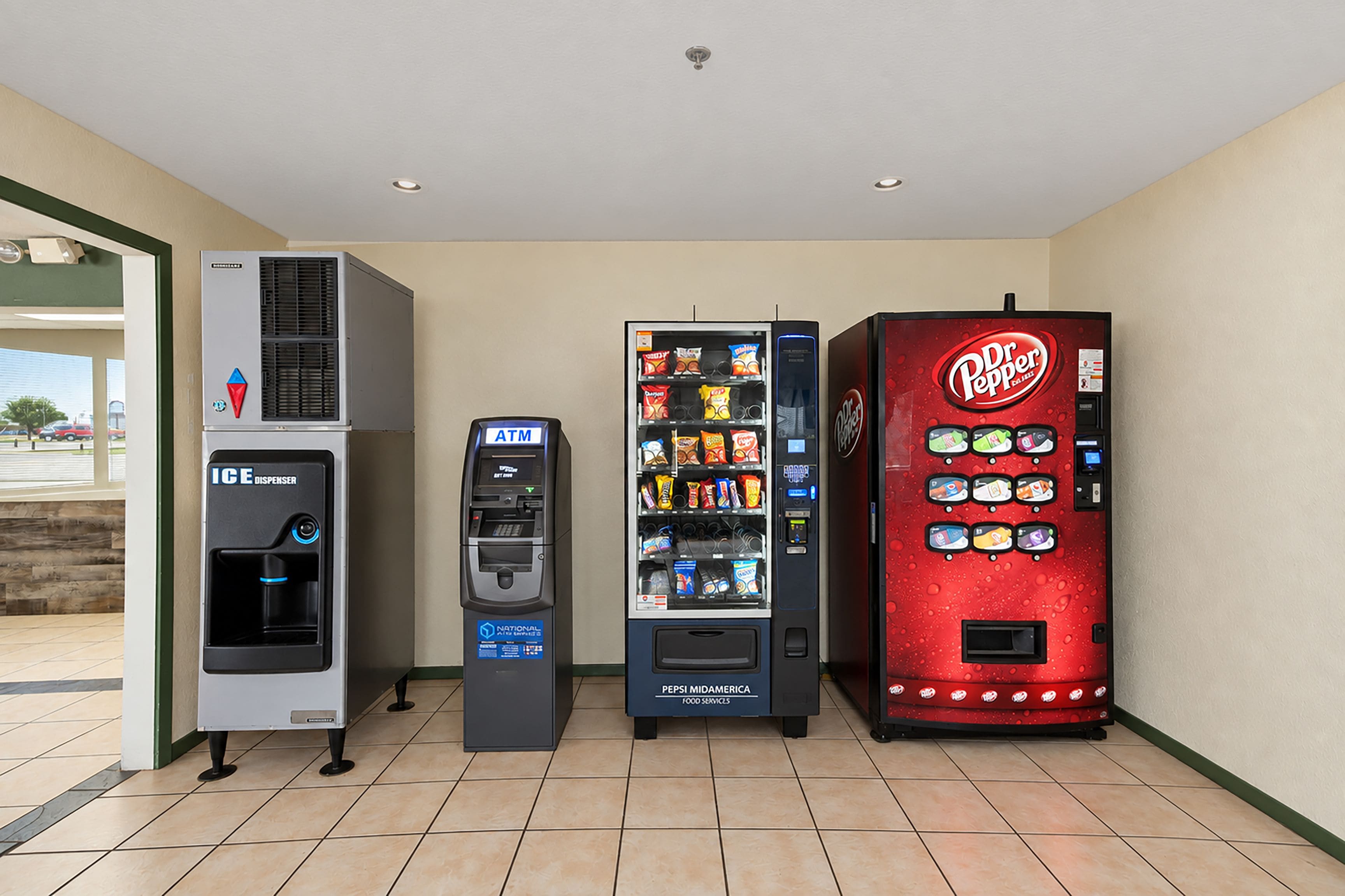 A row of vending machines including an ice dispenser, an ATM, and a Dr Pepper vending machine.