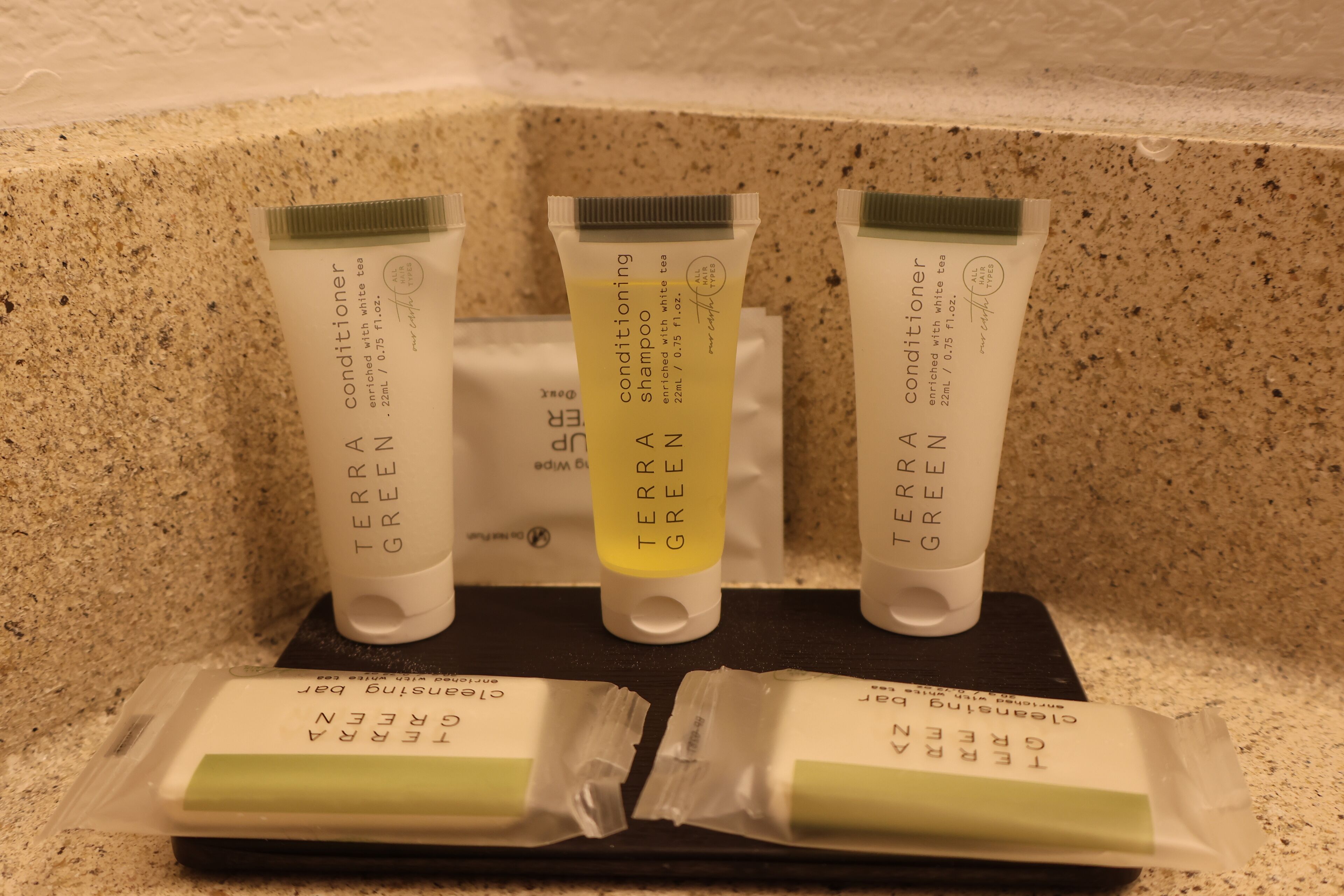 Three tubes of Terra Green conditioner on a countertop.