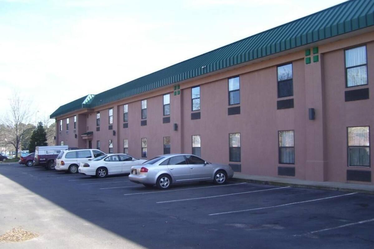 A building with a row of parking spaces and a row of windows.