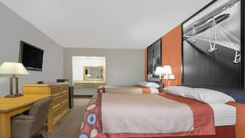 A hotel room with a bed, desk, chair, dresser, and a large window.