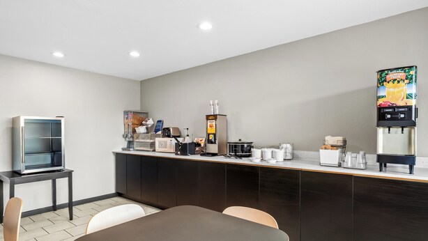 A modern kitchen with a coffee machine, a refrigerator, and a microwave. - Super 8 by Wyndham Farmington (Farmington)