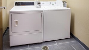 A compact, white, two-door washer and dryer unit with a control panel on top.