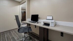 A modern office space with a desk, laptop, printer, and a black office chair. - Sleep Inn Madison (Madison)