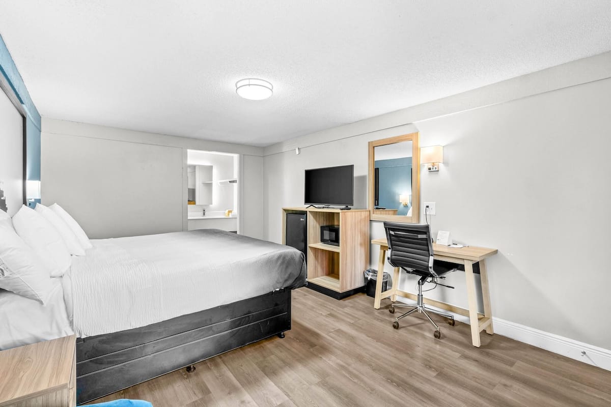 Desk, laptop workspace, blackout drapes, iron/ironing board