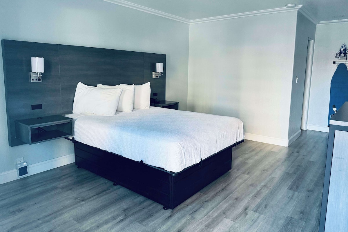 Premium bedding, desk, laptop workspace, blackout drapes