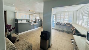 A modern interior with a reception desk, seating area, and a kitchen. - SureStay by Best Western Fresno Central (Fresno)