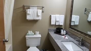 A bathroom with a toilet, sink, and towel rack.