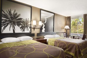 A hotel room with two beds, a large wall mural, a TV, and a window with curtains. - Super 8 by Wyndham Ormond Beach (Ormond Beach)