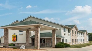 A multi-story hotel with a covered entrance, a Super 8 logo, and a brick facade.