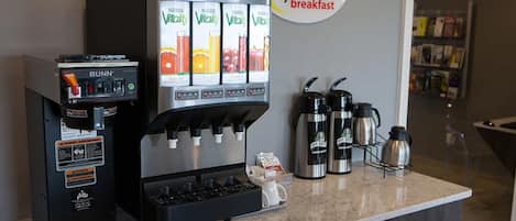 A coffee station with a Bunn espresso machine and a VitaMix juicer, along with two coffee makers on the counter.