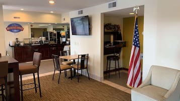 A breakfast area with a counter, chairs, and an American flag.