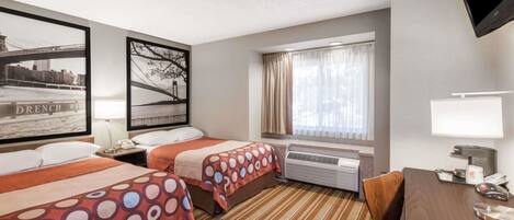 A hotel room with two beds, a desk, a TV, and a window with curtains.