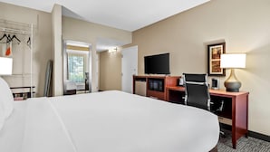 A hotel room with a large bed, a desk with a computer, a television, and a lamp. - Comfort Inn Chambersburg North (Chambersburg)