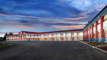 Guests can park their vehicles in the spacious parking lot in front of this motel.