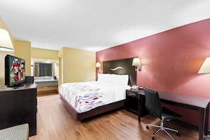 A hotel room with a bed, desk, chair, TV, and lamps. - Red Roof Inn Berea (Berea)