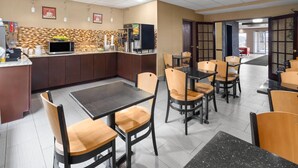 A restaurant with a counter, chairs, and a tiled floor. - Super 8 by Wyndham Mars/Cranberry/Pittsburgh Area (Mars)