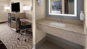 A hotel room with a desk, chair, television, lamp, hairdryer, and a large mirror with a cityscape view. - Super 8 by Wyndham Mars/Cranberry/Pittsburgh Area (Mars)