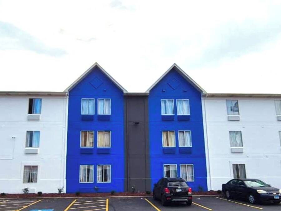 A hotel with a distinctive blue and white facade, featuring a symmetrical design with two main sections.