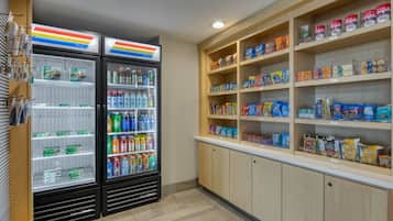A refrigerated beverage display and snack shelves in a store.