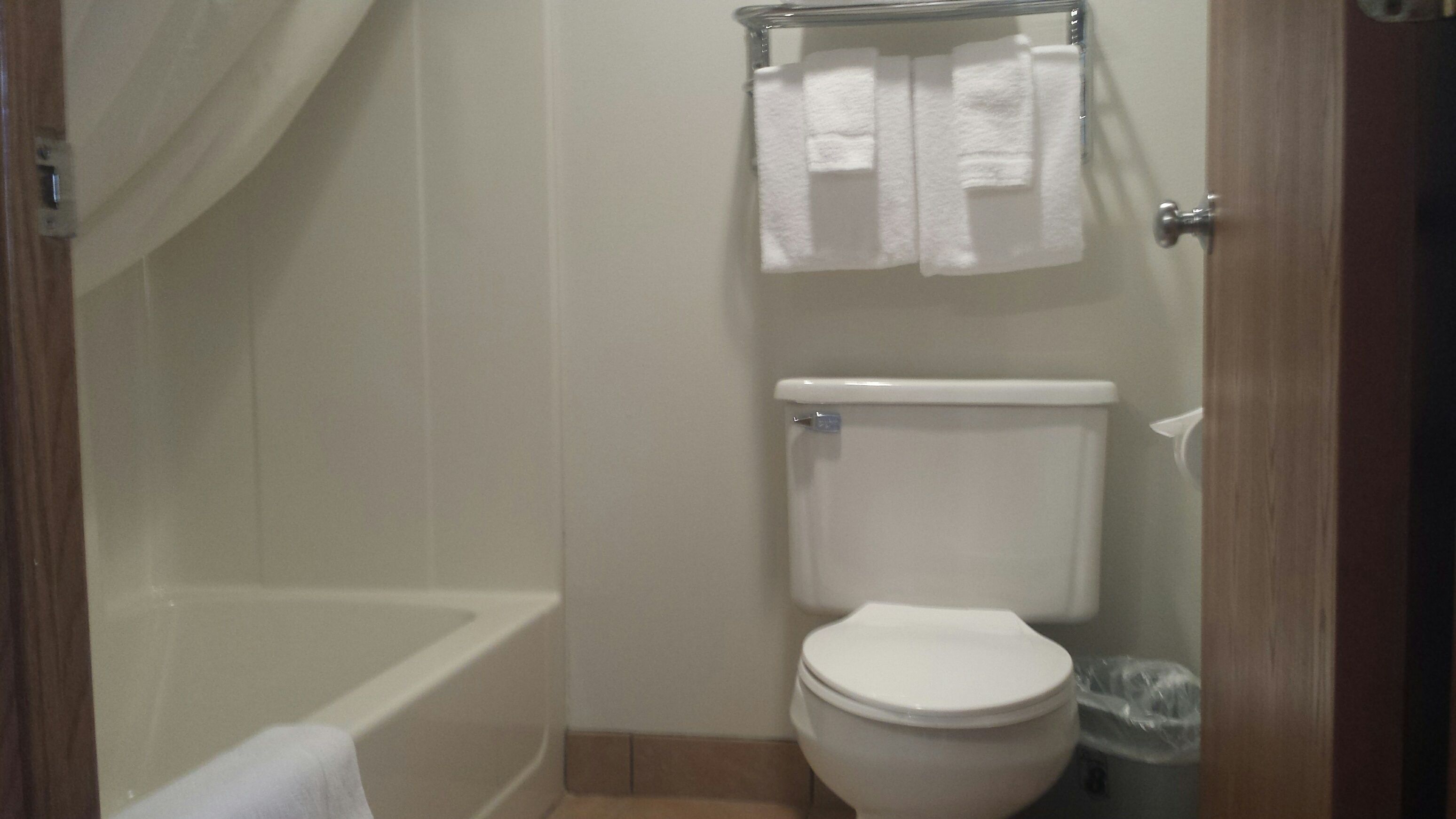 Ein kleines Badezimmer mit Toilette, Badewanne und Duschvorhang.