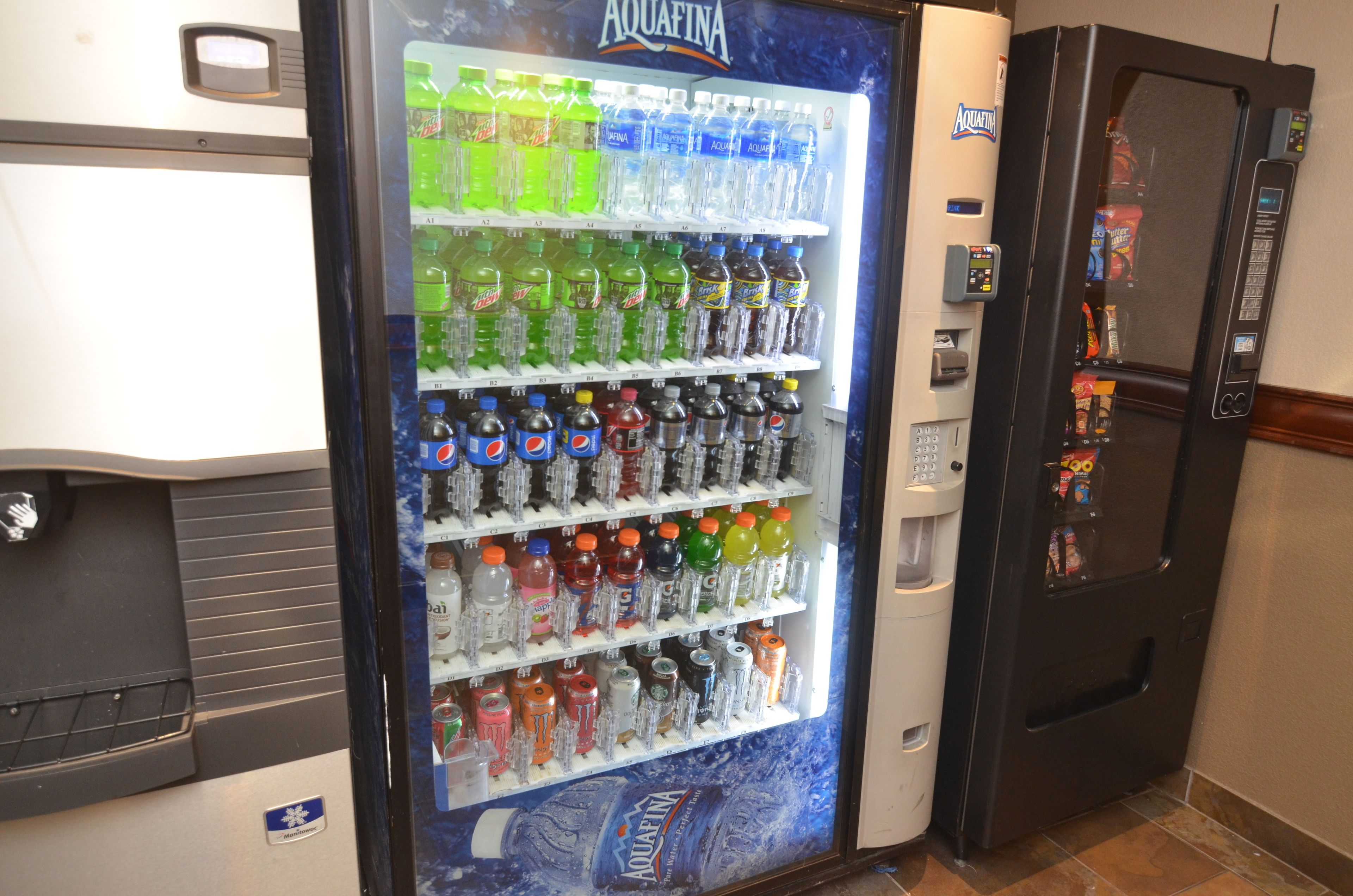A vending machine stocked with various beverages including sodas and water.