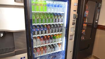A vending machine stocked with various beverages including sodas and water.