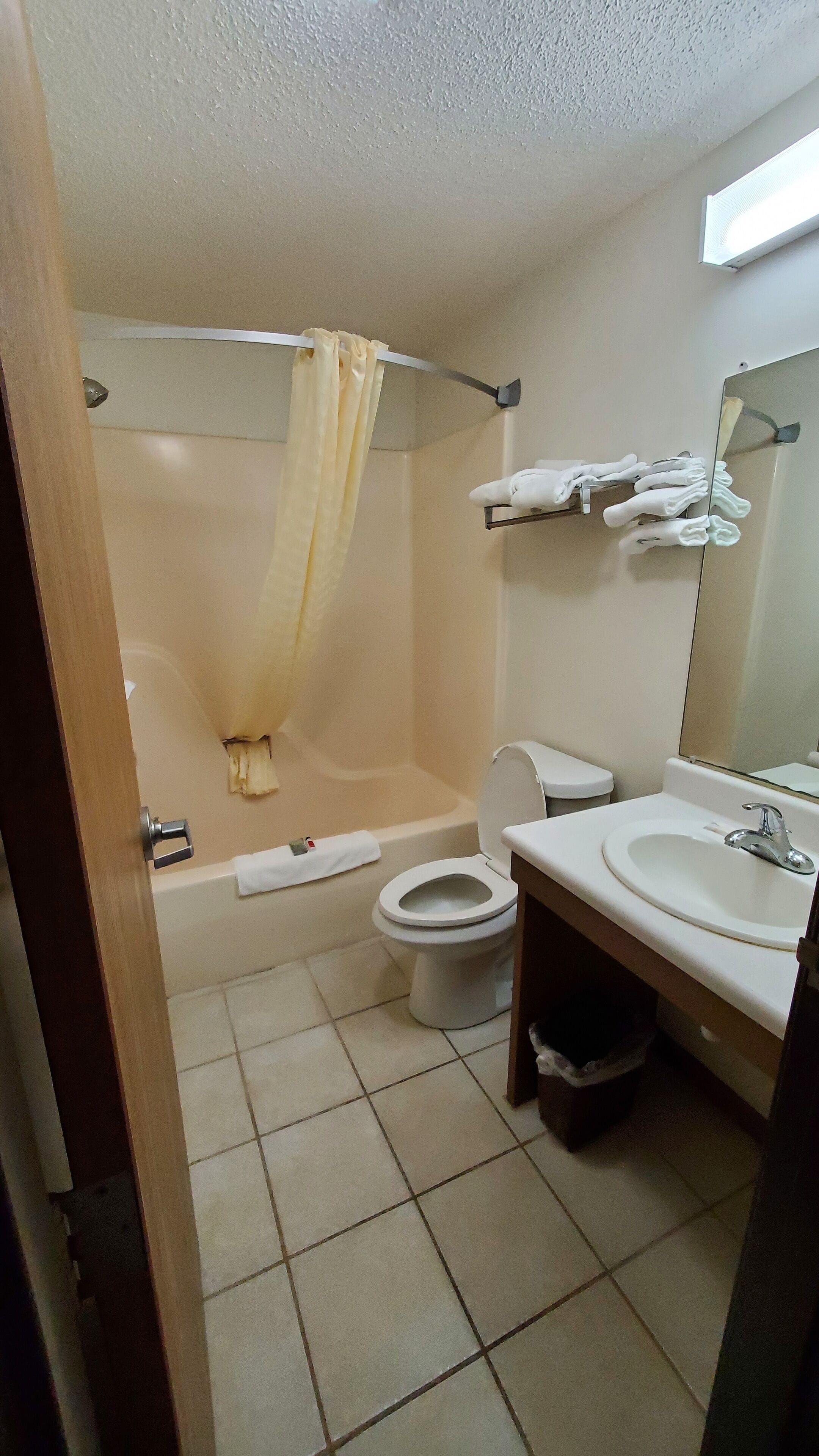 A bathroom with a bathtub, toilet, and sink.