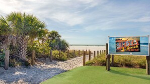 A beach scene with a sign advertising 'SLEEP BEACH in the USA!'