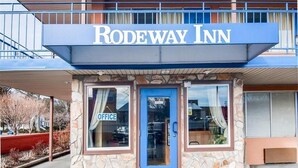 A standalone building with a sign reading "RODEWAY INN" above the entrance. - Econo Lodge Galax (Galax)