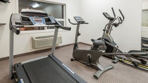 A gym with a treadmill, elliptical, and stationary bike. - Super 8 by Wyndham Edmonton/West (Edmonton)