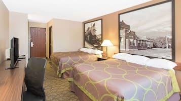A hotel room with two beds, a desk, a chair, and a television.