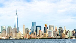 A city skyline with a prominent skyscraper and a variety of other buildings. - Super 8 by Wyndham North Bergen NJ/NYC Area (North Bergen)