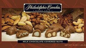 A variety of nuts and chocolate-covered nuts, including almonds, walnuts, pecans, and cashews, with a label indicating they are milk chocolate covered. - Super 8 by Wyndham West Middlesex/Sharon Area (West Middlesex)