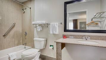 A bathroom with a bathtub, toilet, shower, and sink.