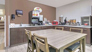 A modern kitchen with a coffee station, microwave, and various appliances. - Super 8 by Wyndham Waxahachie TX (Waxahachie)