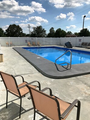 Seasonal outdoor pool, open 10:00 AM to 10:00 PM, pool umbrellas