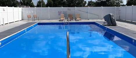 Seasonal outdoor pool, open 10:00 AM to 10:00 PM, pool umbrellas
