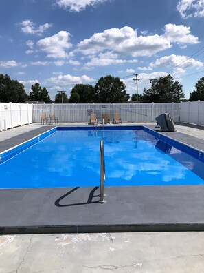 Seasonal outdoor pool, open 10:00 AM to 10:00 PM, pool umbrellas