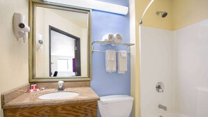 A bathroom with a sink, toilet, and bathtub. There are towels on a rack and a mirror above the sink. - Super 8 by Wyndham Lynchburg VA (Lynchburg)