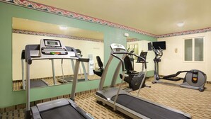 A gym with treadmills, elliptical machines, and a mirrored wall. - Super 8 by Wyndham Lynchburg VA (Lynchburg)